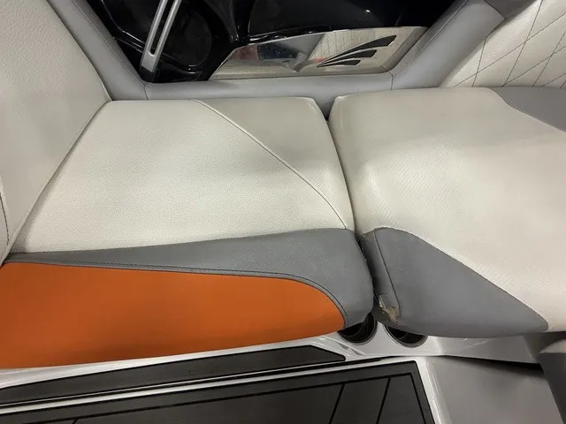 Slide: The Image of Close-up of a boat seat with gray, white, and orange upholstery. - 23