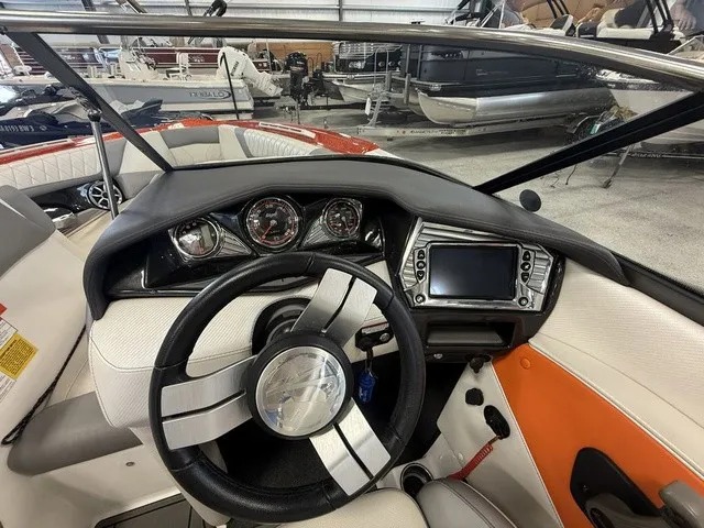 Slide: The Image of The image shows the cockpit of a 2017 Tigé Z3 boat with a modern steering wheel and dashboard. - 28