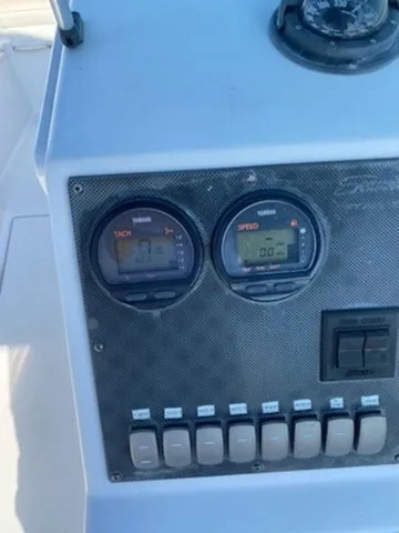 Slide: The Image of The image shows the dashboard of a 2004 Seaswirl 2101 DC Striper with tachometer and switches. - 8