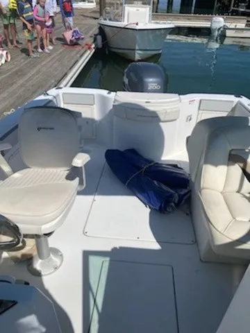 Slide: The Image of The image shows the cockpit of a 2004 Seaswirl 2101 DC Striper with white seats and an outboard motor. - 6