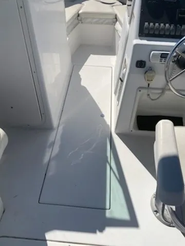 Slide: The Image of The image shows the cockpit of a 2004 Seaswirl 2101 DC Striper with white seats and a helm console. - 4