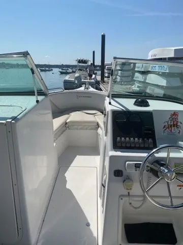 Slide: The Image of A 2004 Seaswirl 2101 DC Striper with open cockpit and helm, docked at a marina. - 3