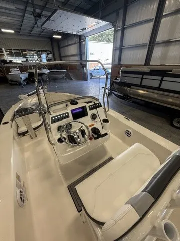 Slide: The Image of The image shows the cockpit of a 2023 Robalo 206 Cayman boat in a warehouse. - 15