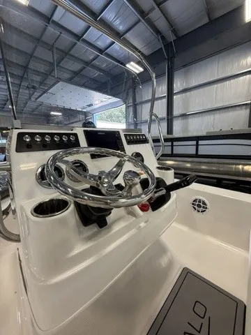 Slide: The Image of The image shows the helm of a 2023 Robalo 206 Cayman with a shiny steering wheel and instruments. - 17