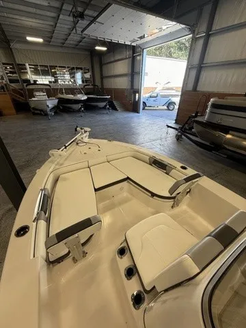 Slide: The Image of The image shows the deck of a 2023 Robalo 206 Cayman in a warehouse. - 22