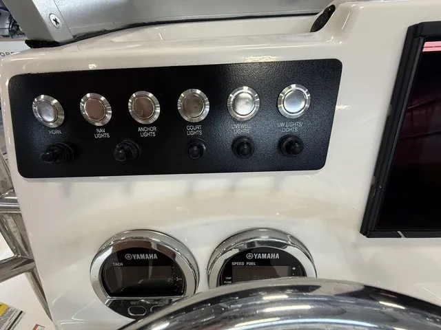 Slide: The Image of The image shows the dashboard of a Robalo 206 Cayman with various switches and Yamaha gauges. - 16