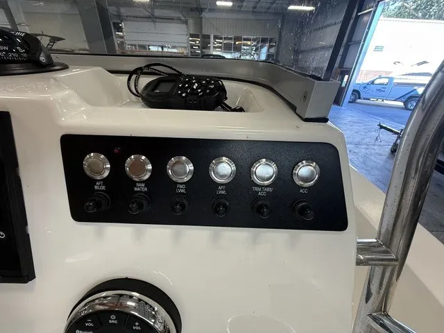 Slide: The Image of The image shows the dashboard of a Robalo 206 Cayman with various switches and buttons. - 18