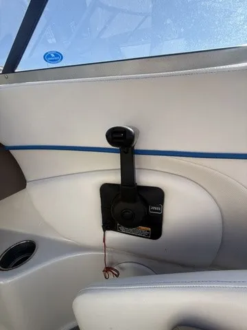 Slide: The Image of Interior view of a boat with white upholstery and a black grab handle on the wall. - 23