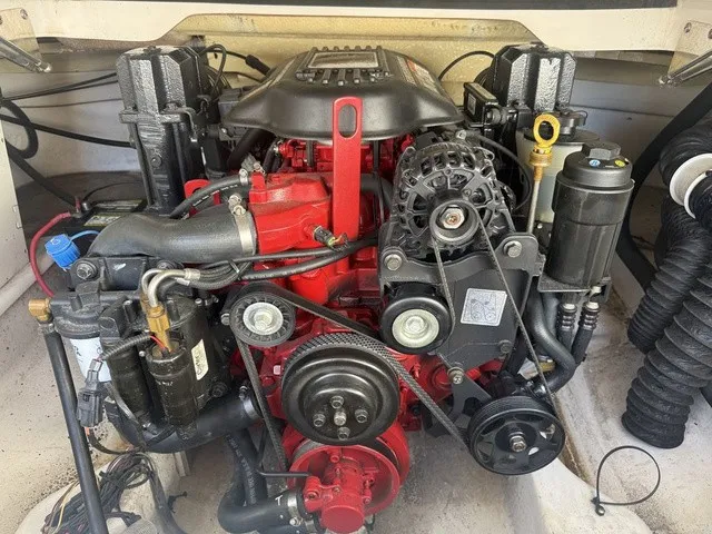 Slide: The Image of A powerful engine in a boat, featuring red and black components, with various hoses and belts visible. - 34