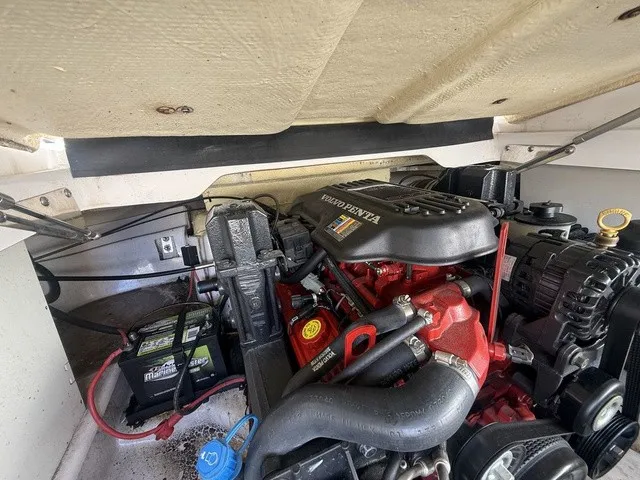 Slide: The Image of A Volvo Penta engine in a boat, surrounded by various components and a battery. - 37