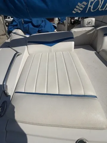 Slide: The Image of The image shows the white upholstery of a sun pad on a boat, accented with blue trim. - 14