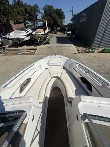 Slide: The Image of The image shows the bow of a 2008 Four Winns H220 boat, situated in a yard. - 15