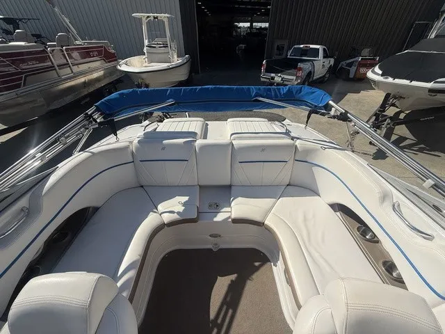Slide: The Image of The image shows the cockpit of a 2008 Four Winns H220 boat with white upholstery. - 29