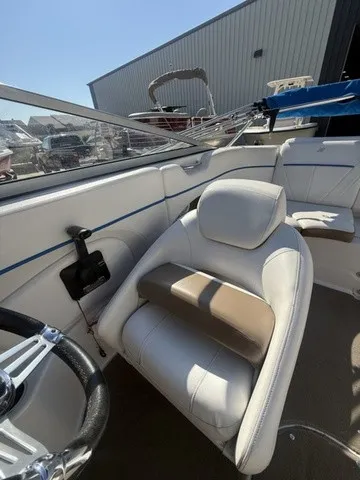 Slide: The Image of The image shows the interior of a 2008 Four Winns H220 boat with white seating. - 25