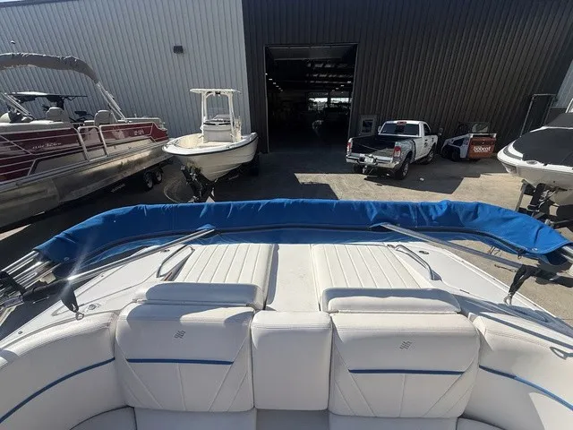 Slide: The Image of The image shows the stern of a 2008 Four Winns H220 boat with blue covers. - 31