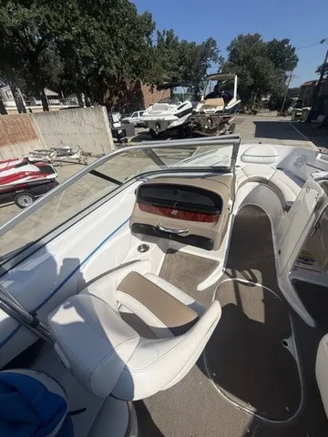 Slide: The Image of The image shows the cockpit of a 2008 Four Winns H220 boat with white seating. - 26