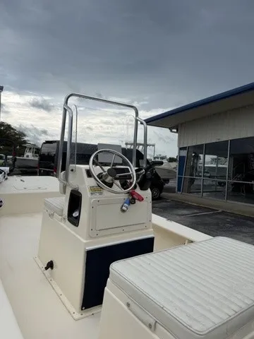 Slide: The Image of The image shows a 2022 Jones Brothers Bateau 17 boat with a helm station and seating. - 2