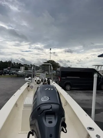 Slide: The Image of A 2022 Jones Brothers Bateau 17 with a 70 HP engine, parked under a cloudy sky. - 4