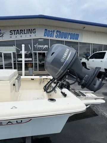 Slide: The Image of A 2022 Jones Brothers Bateau 17 is parked outside a boat showroom with a Yamaha outboard motor. - 3