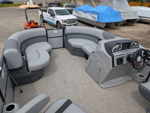 Slide: The Image of The image shows the interior of a 2024 South Bay S222RS pontoon boat with gray seating and a modern helm. - 5