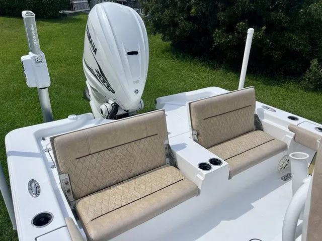 Slide: The Image of The image shows the stern of a 2020 Sportsman Masters 267 Bay Boat with beige seating. - 18