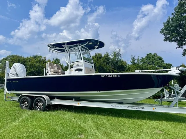 The Image of A 2020 Sportsman Masters 267 Bay Boat on a trailer, set on a grassy field. - 1