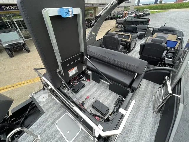Slide: The Image of The image shows the interior of a 2026 Bennington QX Swingback 27 QXSBWAT2 with modern seating. - 35