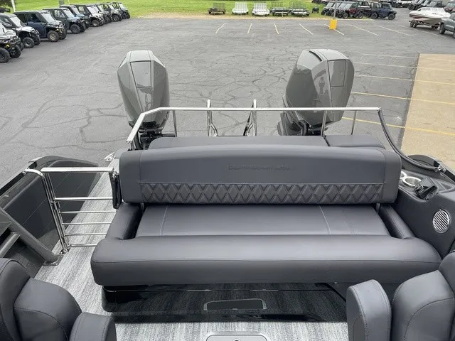 Slide: The Image of The image shows the stern of a Bennington QX Swingback 27 QXSBWAT2 with sleek black upholstery. - 21