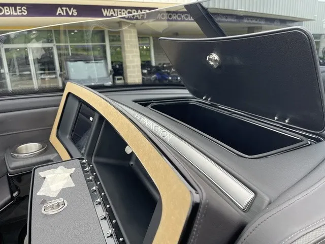 Slide: The Image of The image shows the dashboard of a Bennington QX Swingback 27 QXSBWAT2 with an open storage compartment. - 24