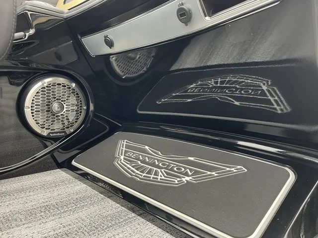 Slide: The Image of The image shows the interior of a Bennington boat with sleek black design and speakers. - 34