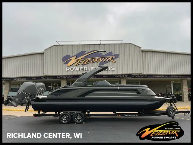 The Image of A sleek Bennington boat on a trailer in front of a store in Richland Center, WI. - 1