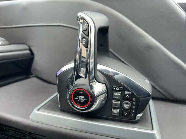 Slide: The Image of Close-up of a modern boat throttle lever with start/stop button and various controls. - 28