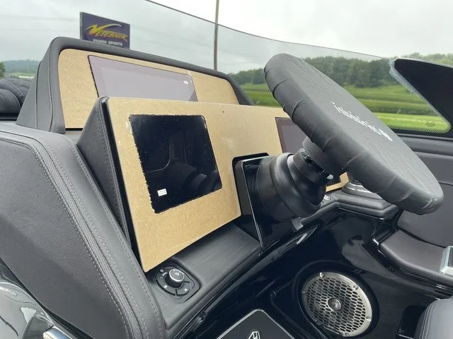 Slide: The Image of The image shows the dashboard of a Bennington QX Swingback 27 QXSBWAT2 with a steering wheel and screens. - 25