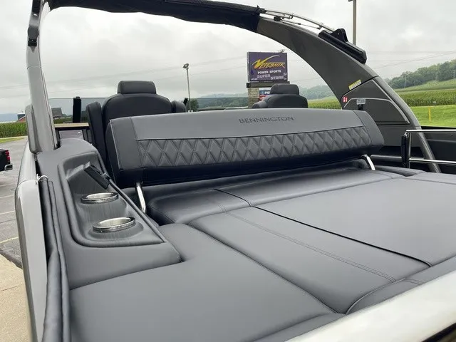 Slide: The Image of The image shows the luxurious rear of a Bennington QX Swingback 27 QXSBWAT2 with sleek seating and cup holders. - 32