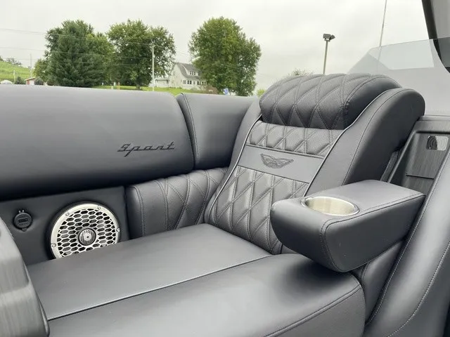 Slide: The Image of Luxurious seating area with quilted leather, speaker, and armrest with cup holder. - 17