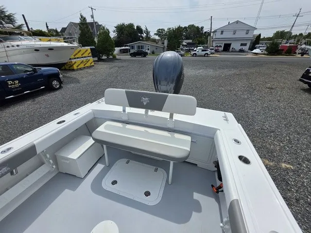 Slide: The Image of The image shows the cockpit of a 2027 Steiger Craft 23 Miami boat with a bench seat and motor. - 3