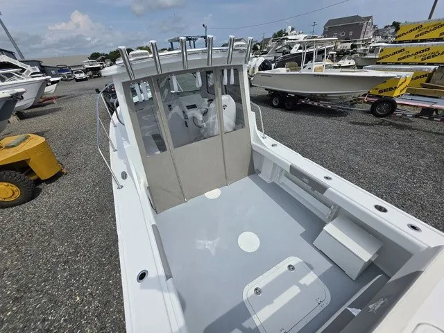 Slide: The Image of The image shows a 2027 Steiger Craft 23 Miami boat with a spacious deck and cabin. - 2