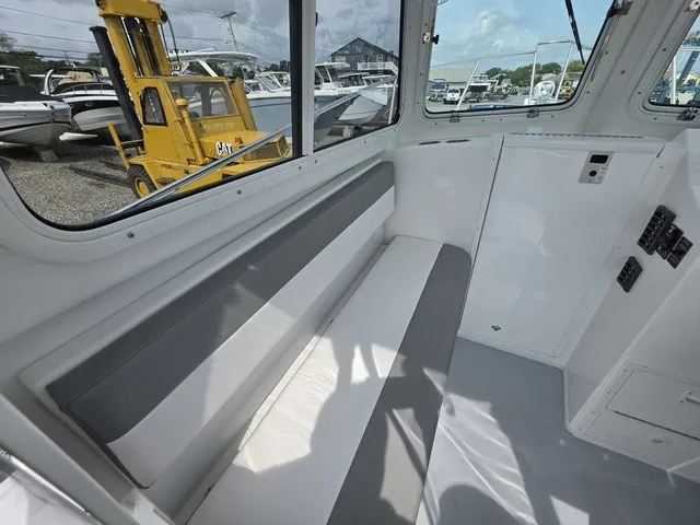 Slide: The Image of Interior of a 2027 Steiger Craft 23 Miami with gray and white seating. - 5