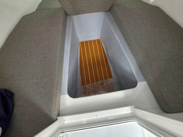 Slide: The Image of Interior of the 2027 Steiger Craft 23 Miami with cushioned seats and wooden flooring. - 8
