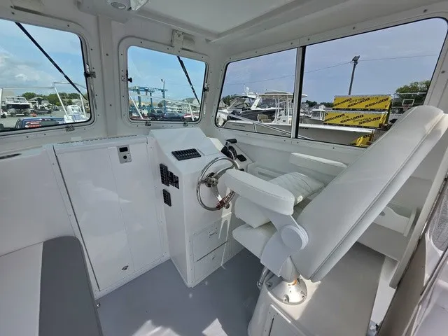 Slide: The Image of Interior of a 2027 Steiger Craft 23 Miami with white seating and helm console. - 4