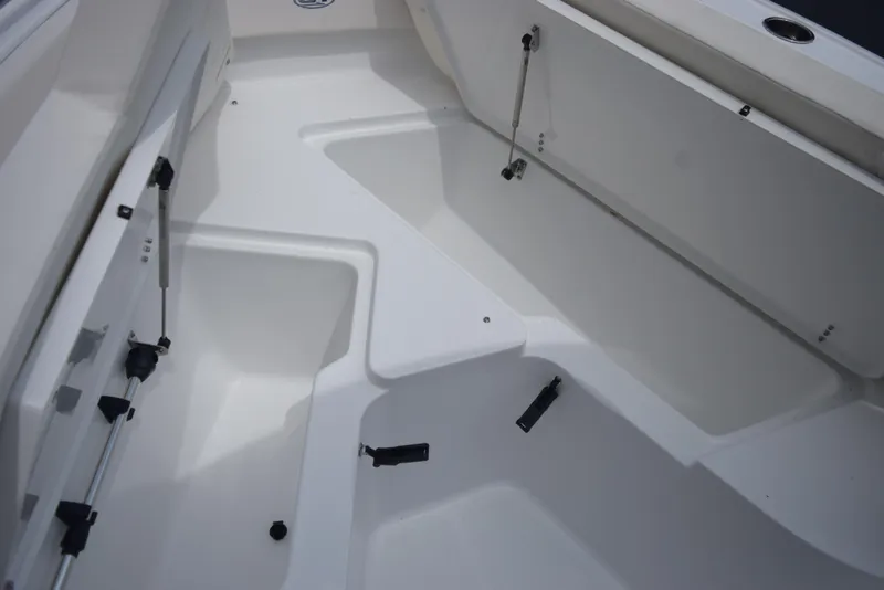 Slide: The Image of The image shows the interior of a 2025 Sea Hunt Ultra 239SE boat with white seating. - 15