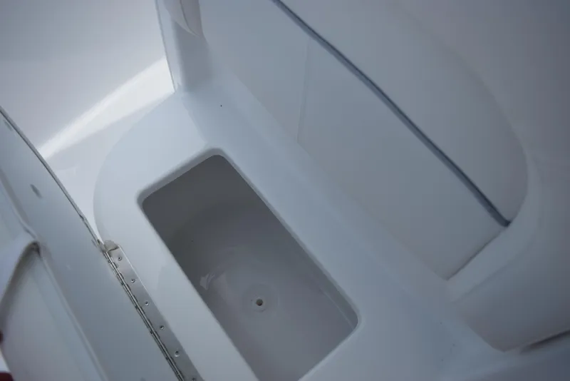 Slide: The Image of A white storage compartment or cooler inside a boat, clean and spacious. - 14