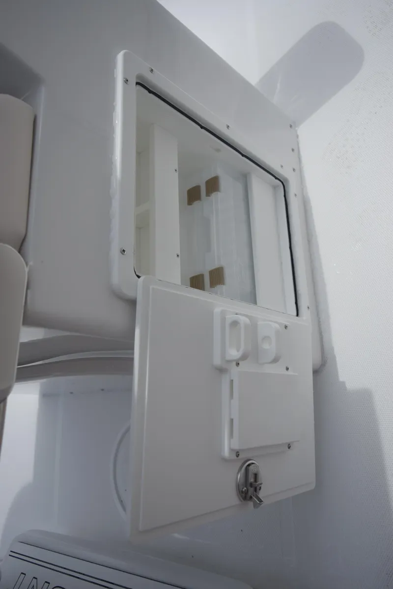 Slide: The Image of A white compartment with a small door and lock, likely on a boat. - 16