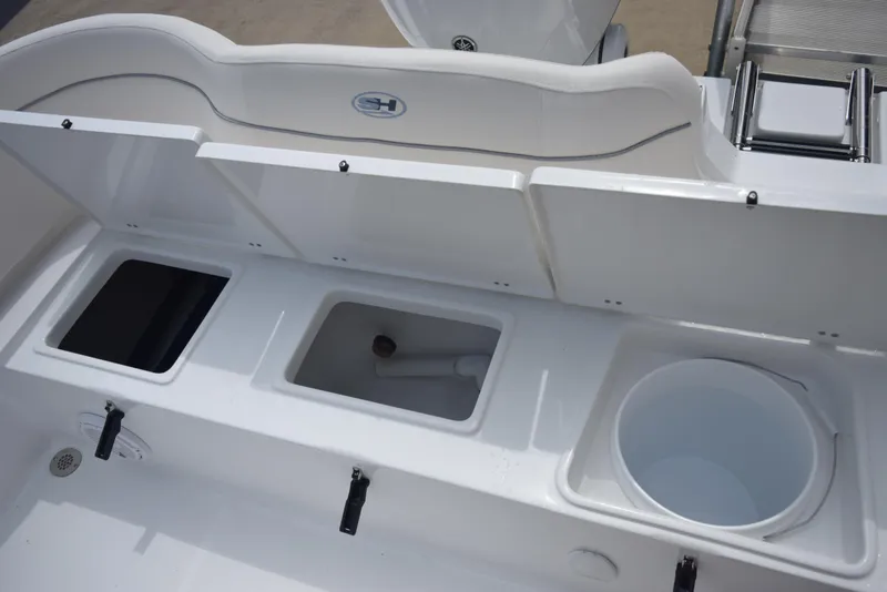 Slide: The Image of The image shows the stern of a Sea Hunt Ultra 239SE boat with multiple storage compartments. - 18