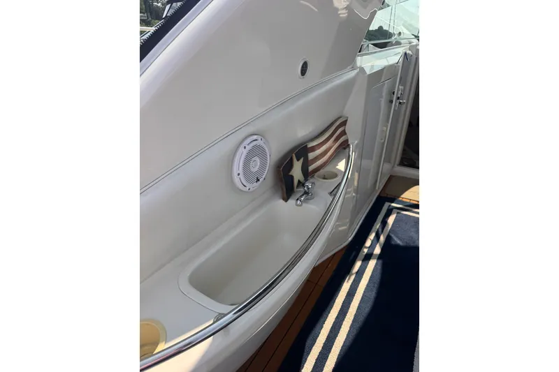 Slide: The Image of Interior view of 1997 Sea Ray 450 Sundancer yacht with speaker and decorative elements. - 14