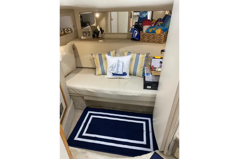 Slide: The Image of Interior of 1997 Sea Ray 450 Sundancer with cozy seating and nautical decor. - 33