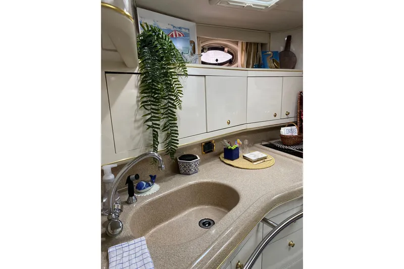 Slide: The Image of Interior of 1997 Sea Ray 450 Sundancer yacht kitchen with sink and cabinets. - 31