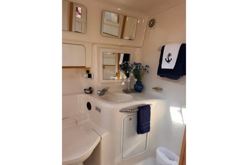 Slide: The Image of Luxurious bathroom interior of 1997 Sea Ray 450 Sundancer yacht with nautical decor. - 38