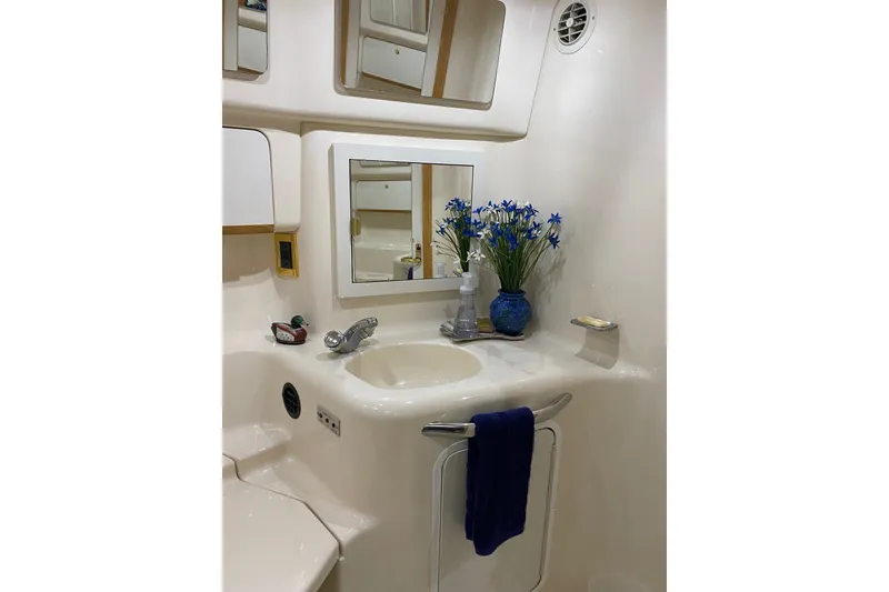 Slide: The Image of Bathroom interior of 1997 Sea Ray 450 Sundancer yacht with sink and floral decor. - 40