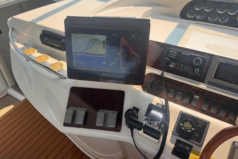 Slide: The Image of Control panel of a 1997 Sea Ray 450 Sundancer with navigation and communication equipment. - 19